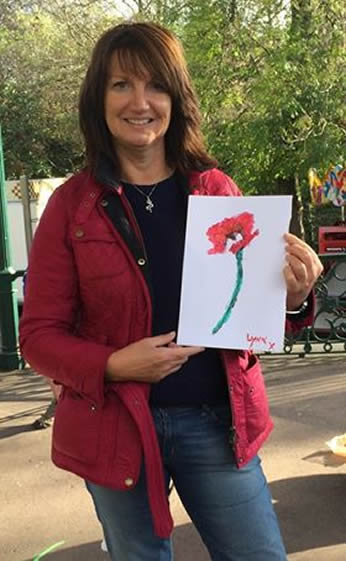 Photo: Lynn showing off her Paint A Poppy painting